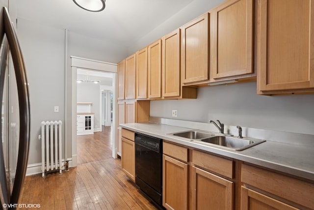 6104 S Kimbark Ave Unit 1, Chicago, IL 60637 - kitchen featuring radiator, dishwasher, a sink, wood-type flooring, and light countertops