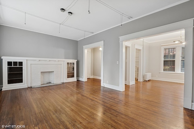 6104 S Kimbark Ave Unit 1, Chicago, IL 60637 - unfurnished living room featuring radiator, wood finished floors, a brick fireplace, baseboards, and ornamental molding
