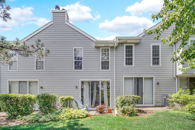517 Woodcrest Dr, Mundelein, IL 60060 - rear view of house with a lawn, a chimney, and a patio area