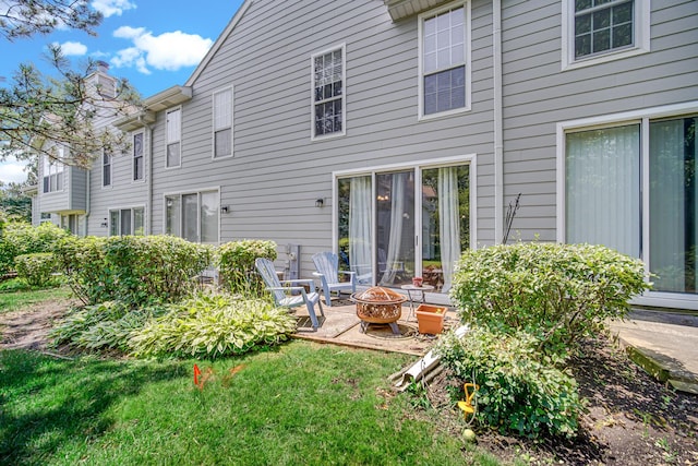 517 Woodcrest Dr, Mundelein, IL 60060 - rear view of property with an outdoor fire pit, a chimney, and a yard