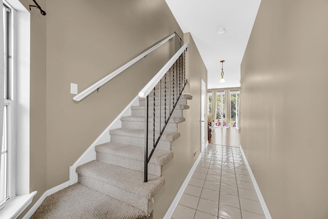517 Woodcrest Dr, Mundelein, IL 60060 - staircase featuring tile patterned floors and baseboards