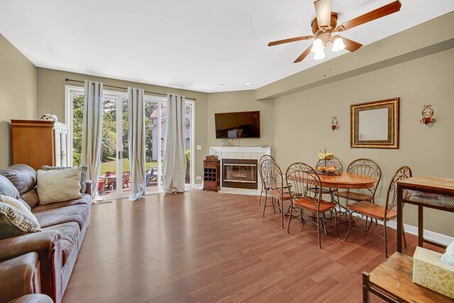 517 Woodcrest Dr, Mundelein, IL 60060 - living area featuring light wood-style floors, ceiling fan, and a tiled fireplace