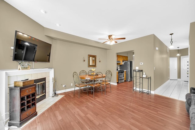 517 Woodcrest Dr, Mundelein, IL 60060 - living room with light wood-style flooring, a ceiling fan, and a fireplace