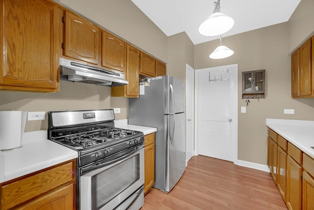 517 Woodcrest Dr, Mundelein, IL 60060 - kitchen with appliances with stainless steel finishes, under cabinet range hood, light countertops, and light wood-style flooring
