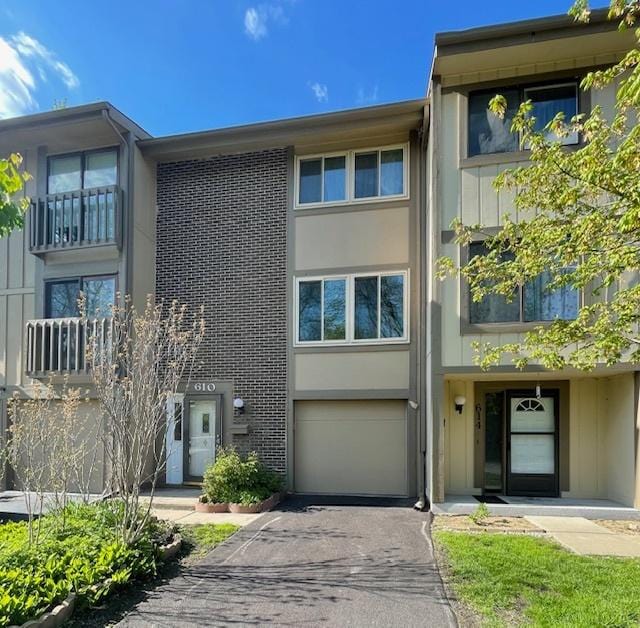 610 E Woodfield Trl, Roselle, IL 60172 - view of property with driveway, a garage, and brick siding