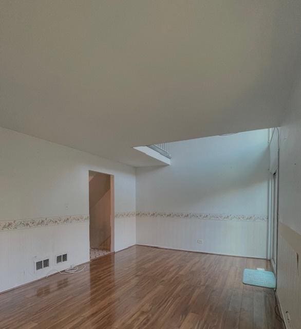 610 E Woodfield Trl, Roselle, IL 60172 - empty room featuring wood finished floors and a wainscoted wall