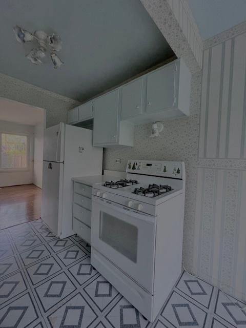 610 E Woodfield Trl, Roselle, IL 60172 - kitchen with white appliances, white cabinetry, and light countertops