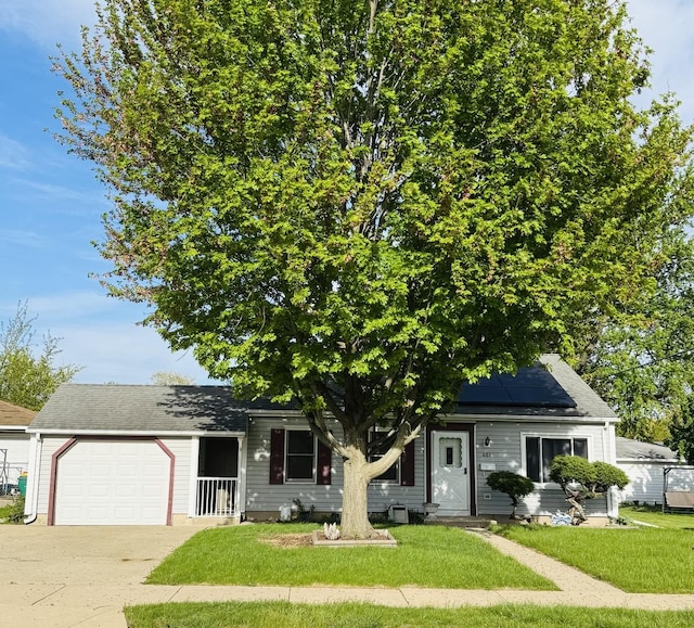 603 Kingston Dr, Romeoville, IL 60446 - view of front of house featuring a front lawn, a garage, roof mounted solar panels, and driveway