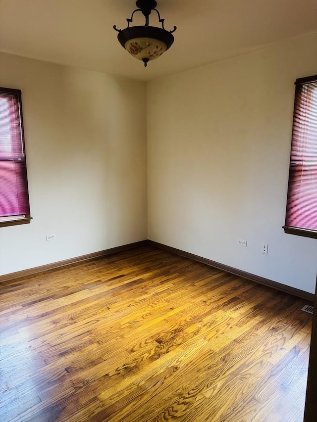 603 Kingston Dr, Romeoville, IL 60446 - spare room featuring wood finished floors and baseboards