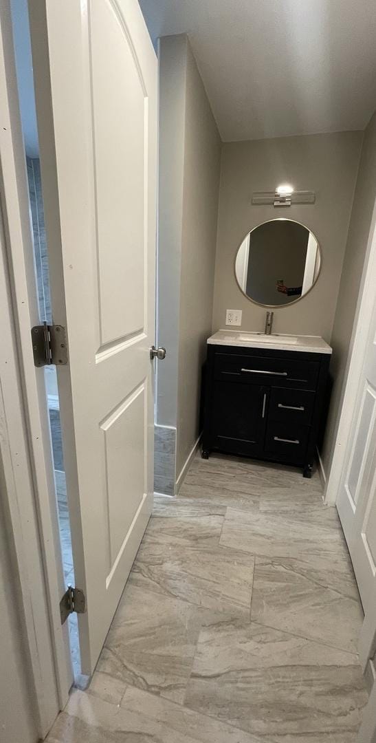 bathroom with vanity, baseboards, and marble finish floor