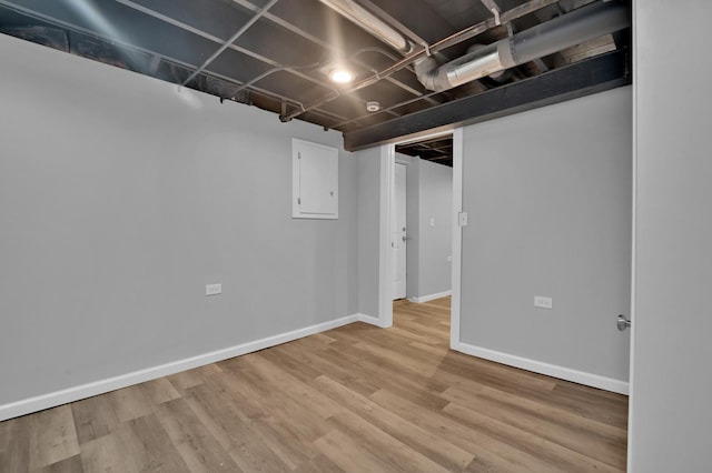 finished basement featuring baseboards and wood finished floors