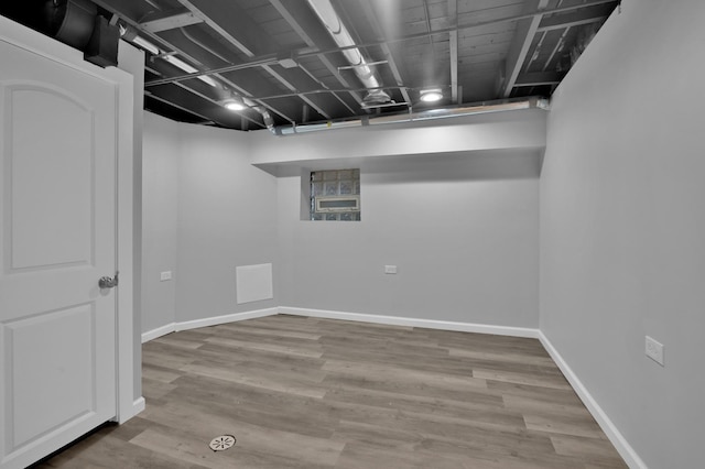 finished basement featuring baseboards and wood finished floors