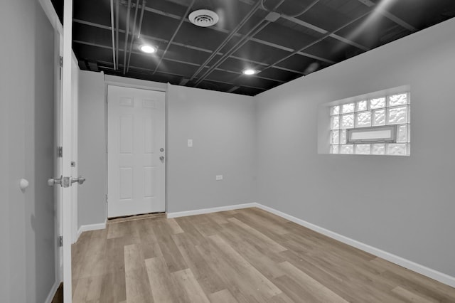 unfurnished room with visible vents, light wood-style flooring, and baseboards