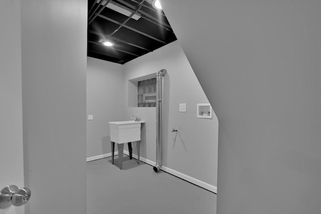 laundry area featuring laundry area, washer hookup, and baseboards