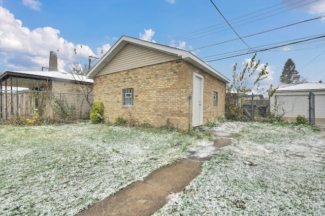 view of property exterior featuring brick siding and fence
