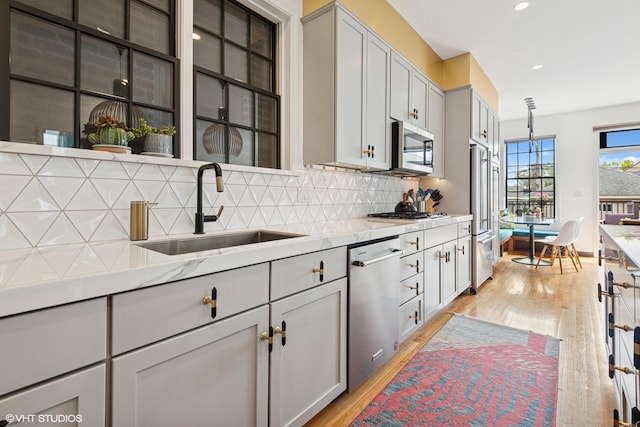 837 W 34th Pl, Chicago, IL 60608 - kitchen featuring a sink, stainless steel appliances, light wood-type flooring, tasteful backsplash, and recessed lighting