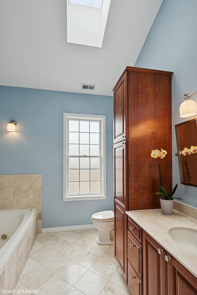 837 W 34th Pl, Chicago, IL 60608 - full bath with a skylight, a jetted tub, vanity, baseboards, and toilet