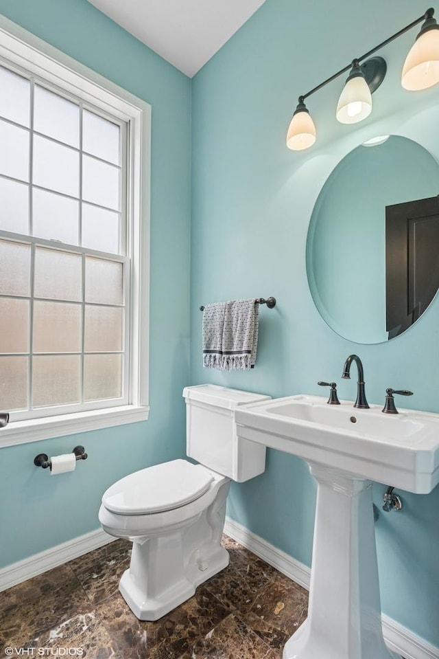 837 W 34th Pl, Chicago, IL 60608 - bathroom with baseboards, toilet, plenty of natural light, and a sink