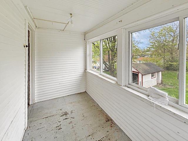 unfurnished sunroom with plenty of natural light