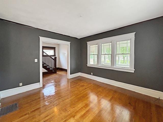 empty room featuring baseboards and wood finished floors