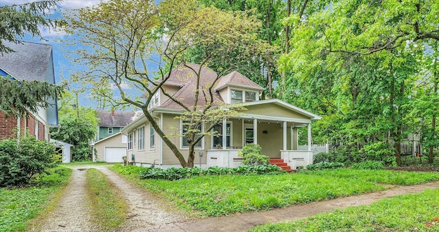 709 W Oregon St, Urbana, IL 61801 - bungalow with a porch, an outdoor structure, and a garage
