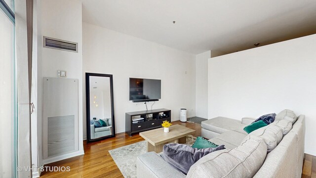 340 W Superior St Unit 1602, Chicago, IL 60654 - living area featuring wood finished floors, a heating unit, and baseboards