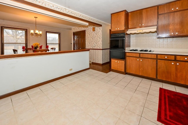 249 S Arlington Heights Rd, Elk Grove Village, IL 60007 - kitchen featuring brown cabinets, under cabinet range hood, a chandelier, light countertops, and wallpapered walls