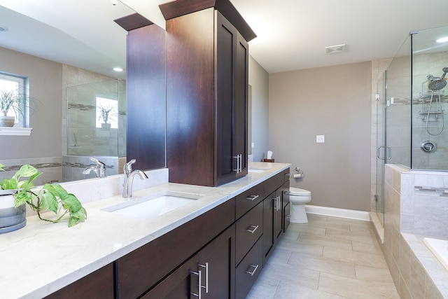 12911 Mayfair Dr, Lemont, IL 60439 - full bathroom featuring toilet, a shower stall, double vanity, baseboards, and tile patterned floors