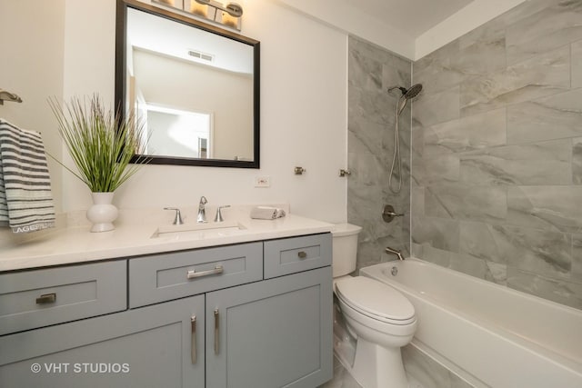 bathroom featuring toilet, vanity, visible vents, and tub / shower combination