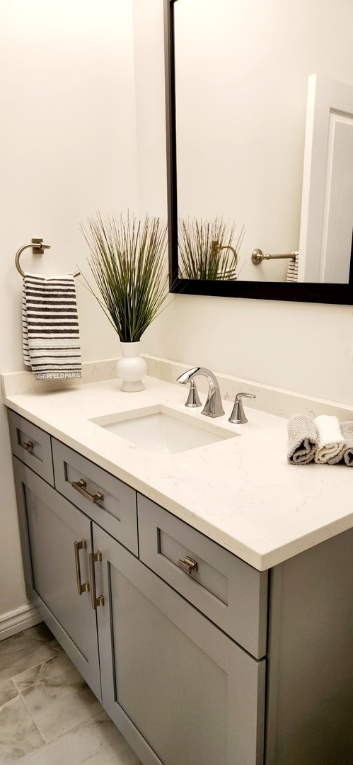 bathroom with vanity and marble finish floor