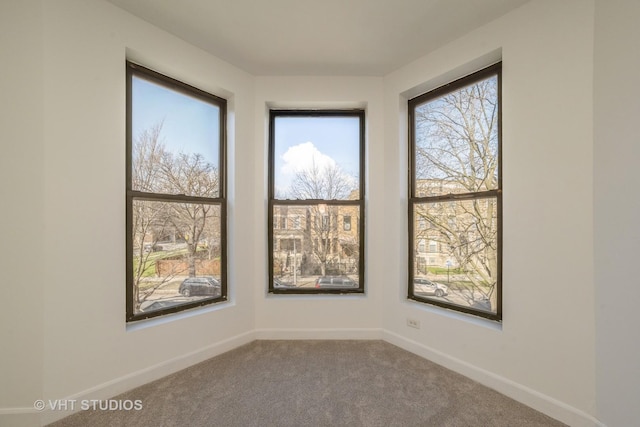 spare room with carpet and baseboards