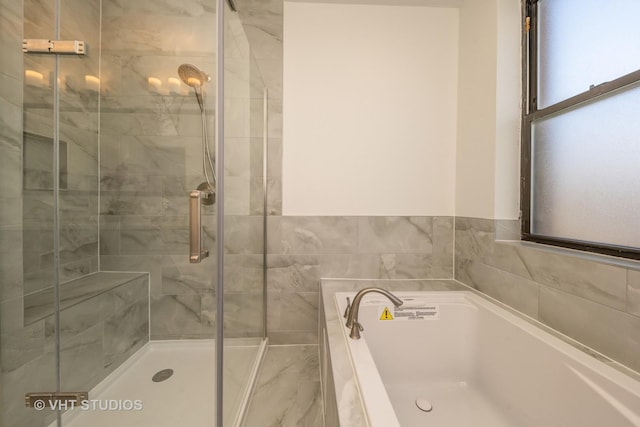 full bath with a garden tub and a stall shower