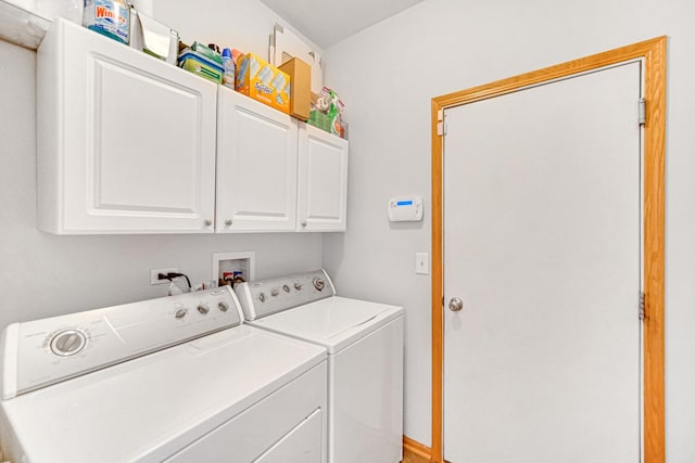washroom featuring washing machine and clothes dryer and cabinet space