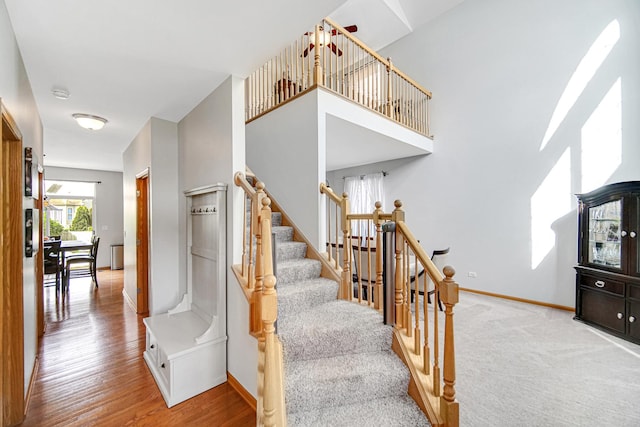 stairs with baseboards and wood finished floors