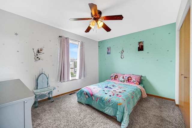 carpeted bedroom with baseboards, ceiling fan, and a closet