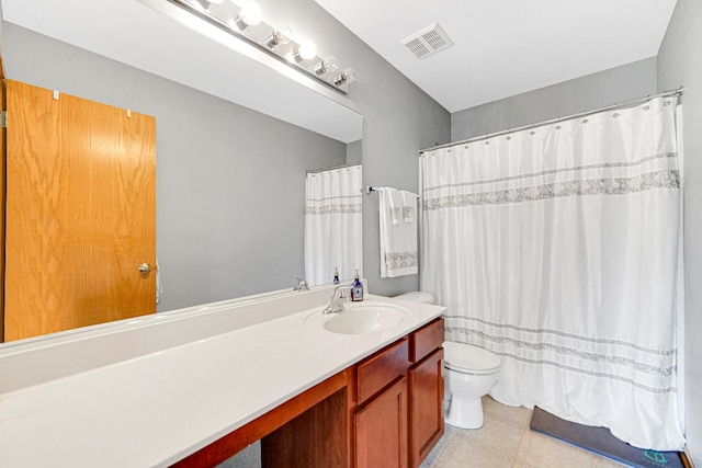 full bathroom featuring toilet, vanity, tile patterned floors, and a shower with curtain