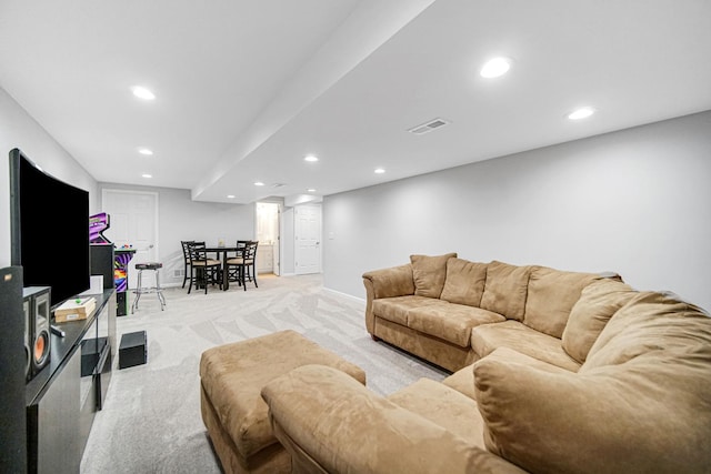 living room with recessed lighting, light colored carpet, and baseboards
