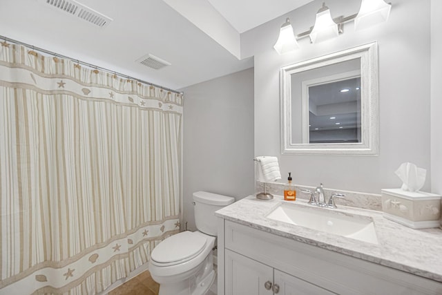 bathroom featuring toilet, vanity, and a shower with shower curtain