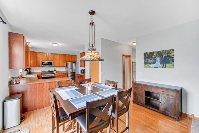 dining space featuring light wood-type flooring