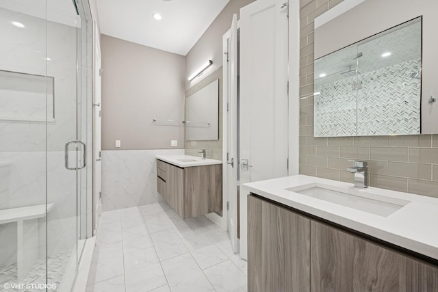 216 S Green St Unit 1N, Chicago, IL 60607 - bathroom featuring tile walls, marble look tile flooring, a marble finish shower, two vanities, and recessed lighting
