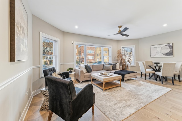 living area featuring baseboards, recessed lighting, ceiling fan, and wood finished floors