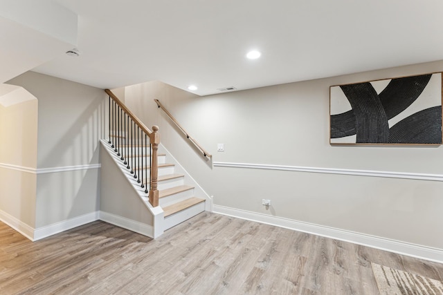 basement with stairs, wood finished floors, visible vents, recessed lighting, and baseboards