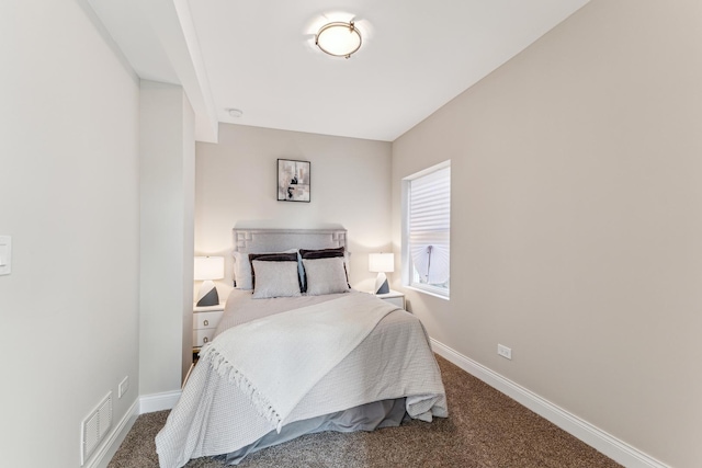 carpeted bedroom with visible vents and baseboards