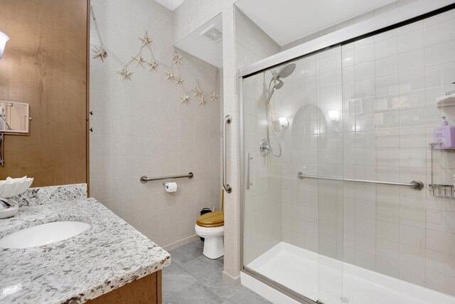390 S Western Ave Unit 703, Des Plaines, IL 60016 - bathroom with a stall shower, tile walls, toilet, visible vents, and vanity