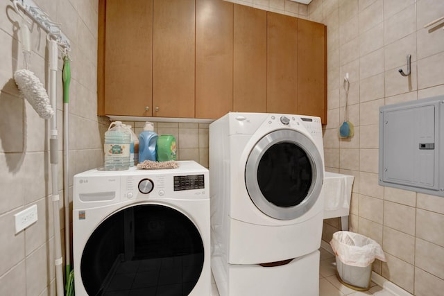 390 S Western Ave Unit 703, Des Plaines, IL 60016 - clothes washing area featuring electric panel, tile walls, cabinet space, independent washer and dryer, and tile patterned flooring
