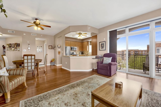 390 S Western Ave Unit 703, Des Plaines, IL 60016 - living room featuring baseboards, visible vents, ceiling fan, and wood finished floors
