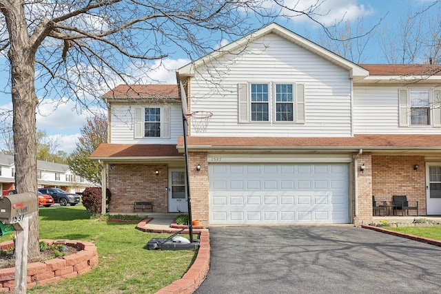 view of front facade featuring brick siding, an attached garage, driveway, and a front lawn
