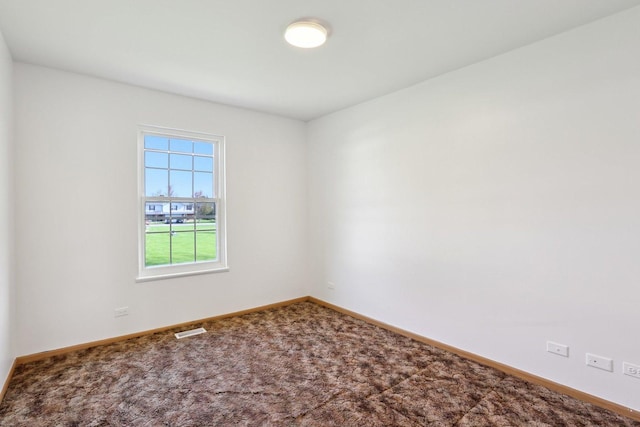 unfurnished room featuring baseboards and carpet flooring