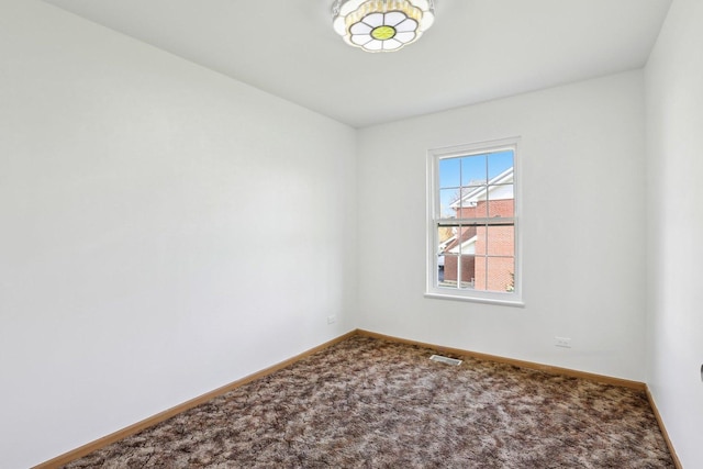 empty room with baseboards and carpet flooring