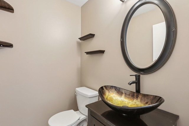 half bathroom with vanity and toilet